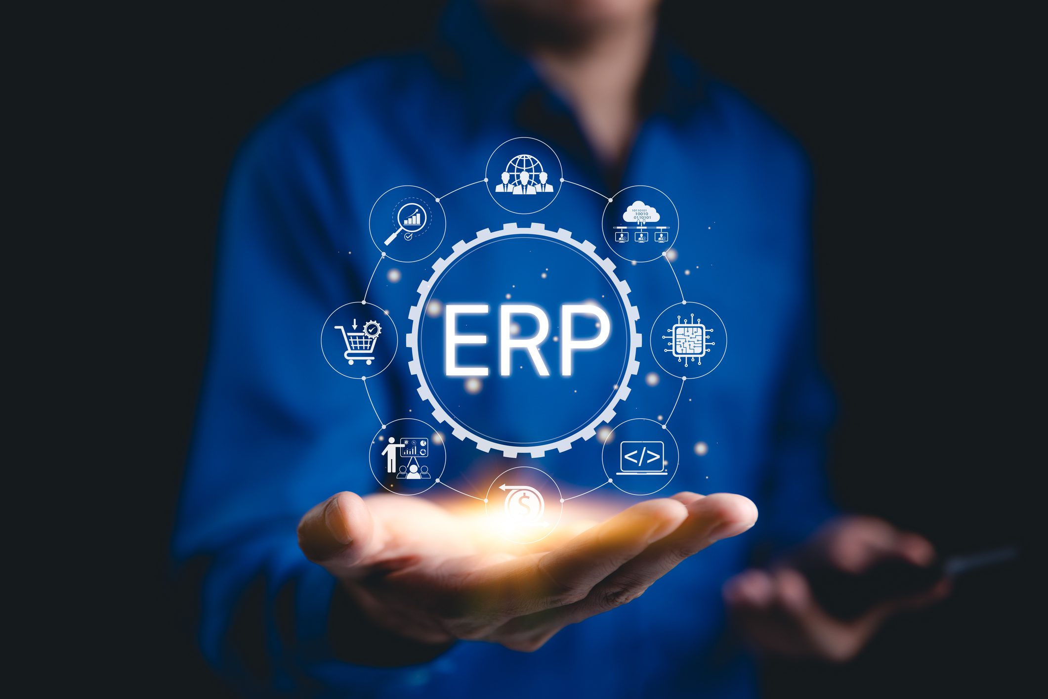 Businessman holding glowing ERP symbol