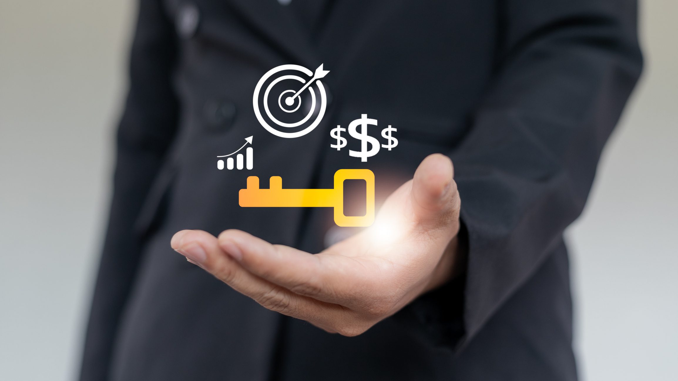 Hand holding key to business success