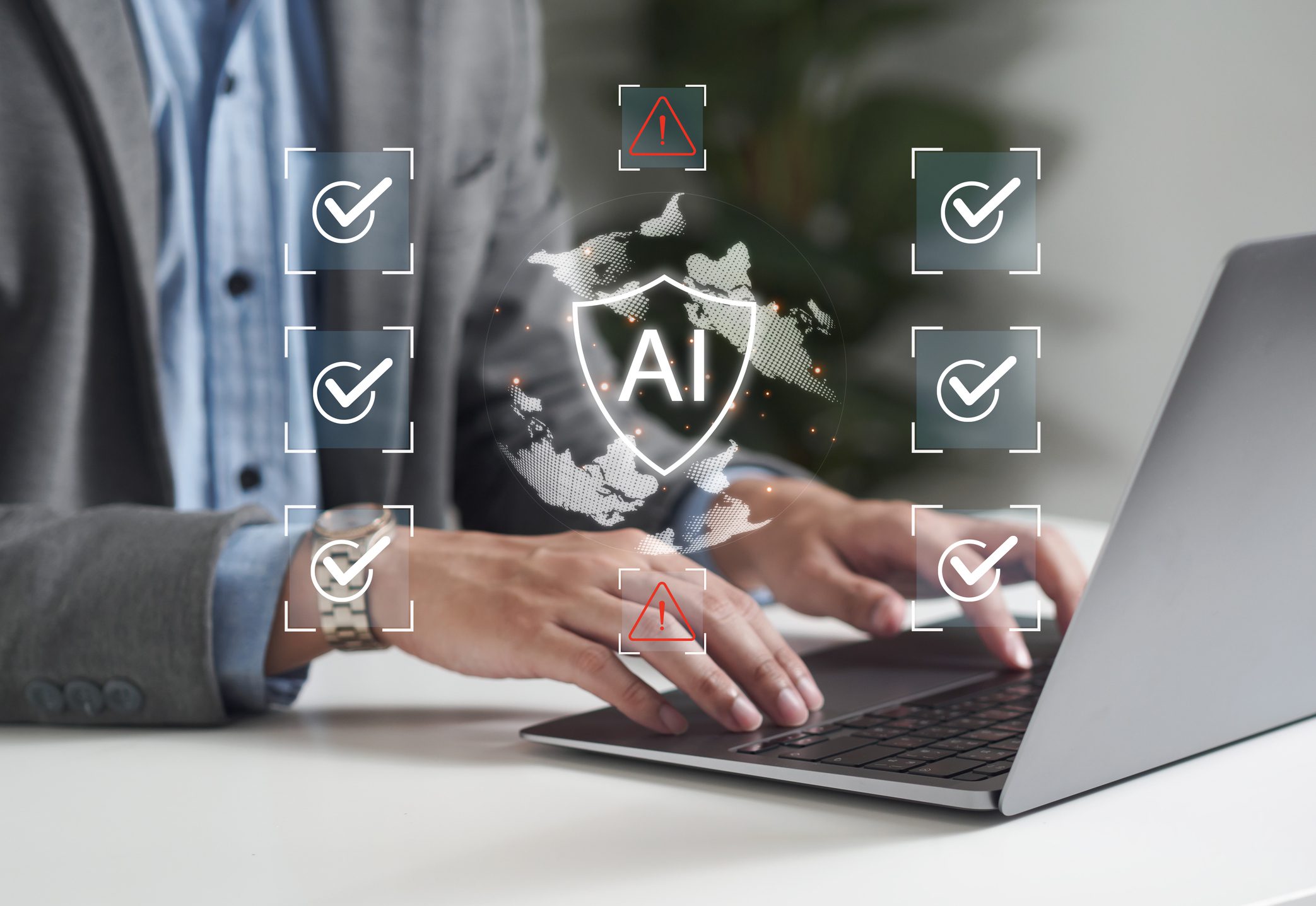 Person typing on laptop with AI hologram